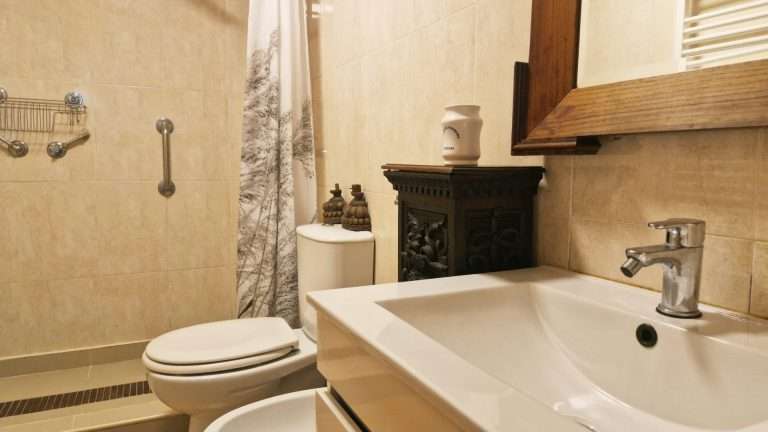 Casa de banho com duche, lavatório e espelho
